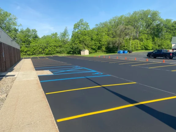 Completed asphalt paving project with well-defined parking spaces.