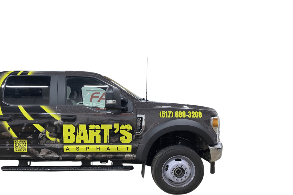 a black truck with yellow writing on the side